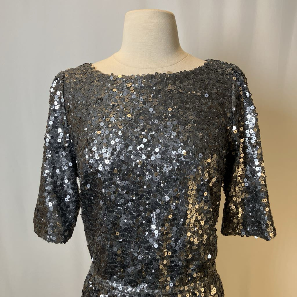 Black sequin top on a mannequin against a neutral background
