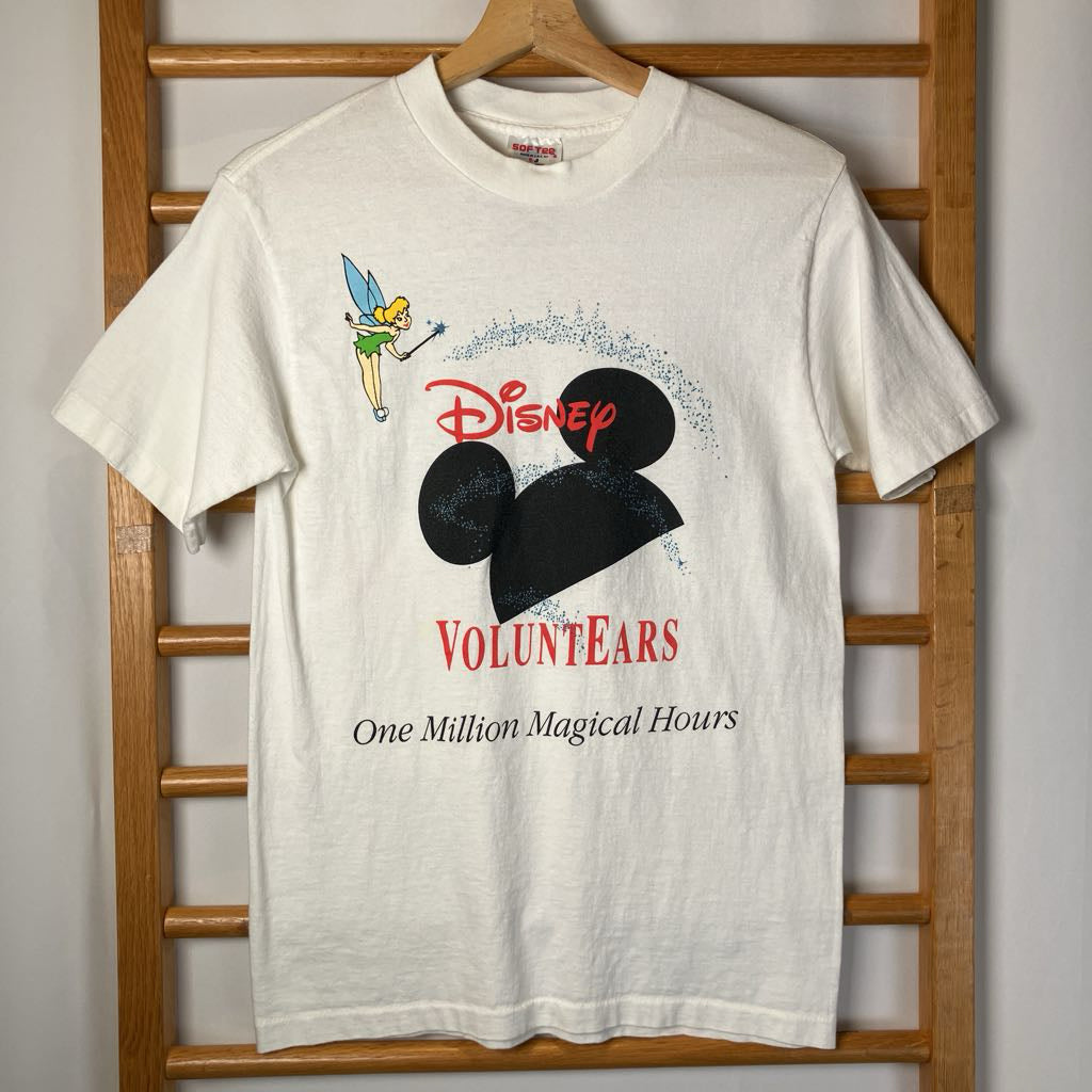 White t-shirt with Disney VoluntEARS design on a wooden hanger