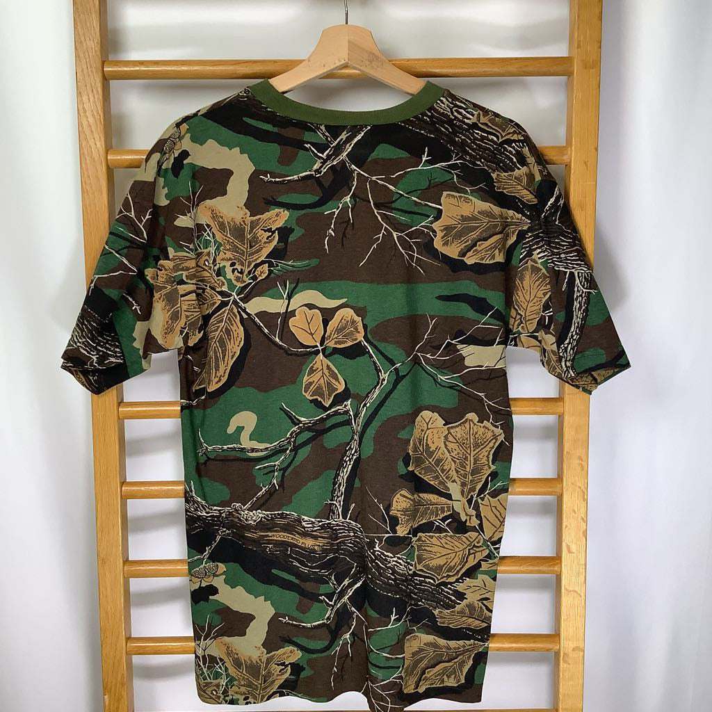Camouflage-patterned shirt on a wooden hanger against a white background