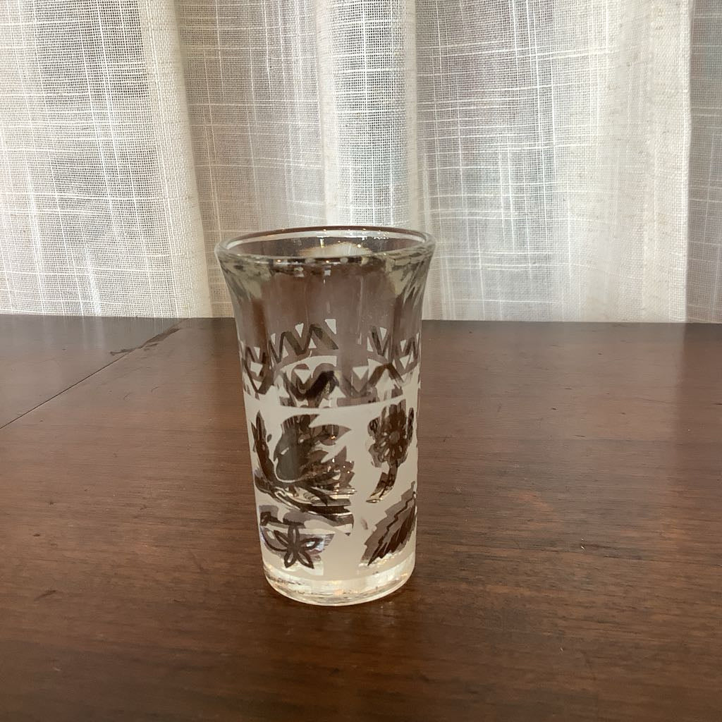 Clear glass with floral pattern on a wooden table