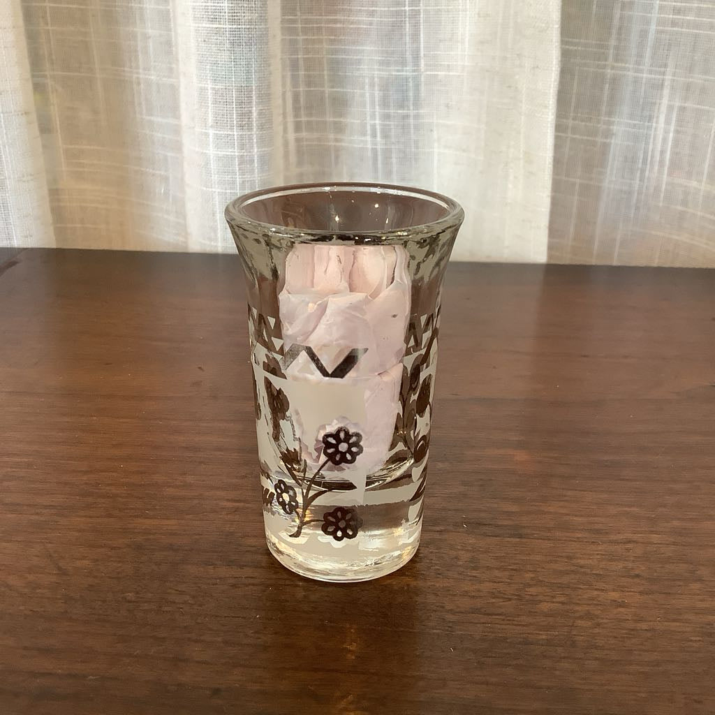 Clear glass with floral design on a wooden surface