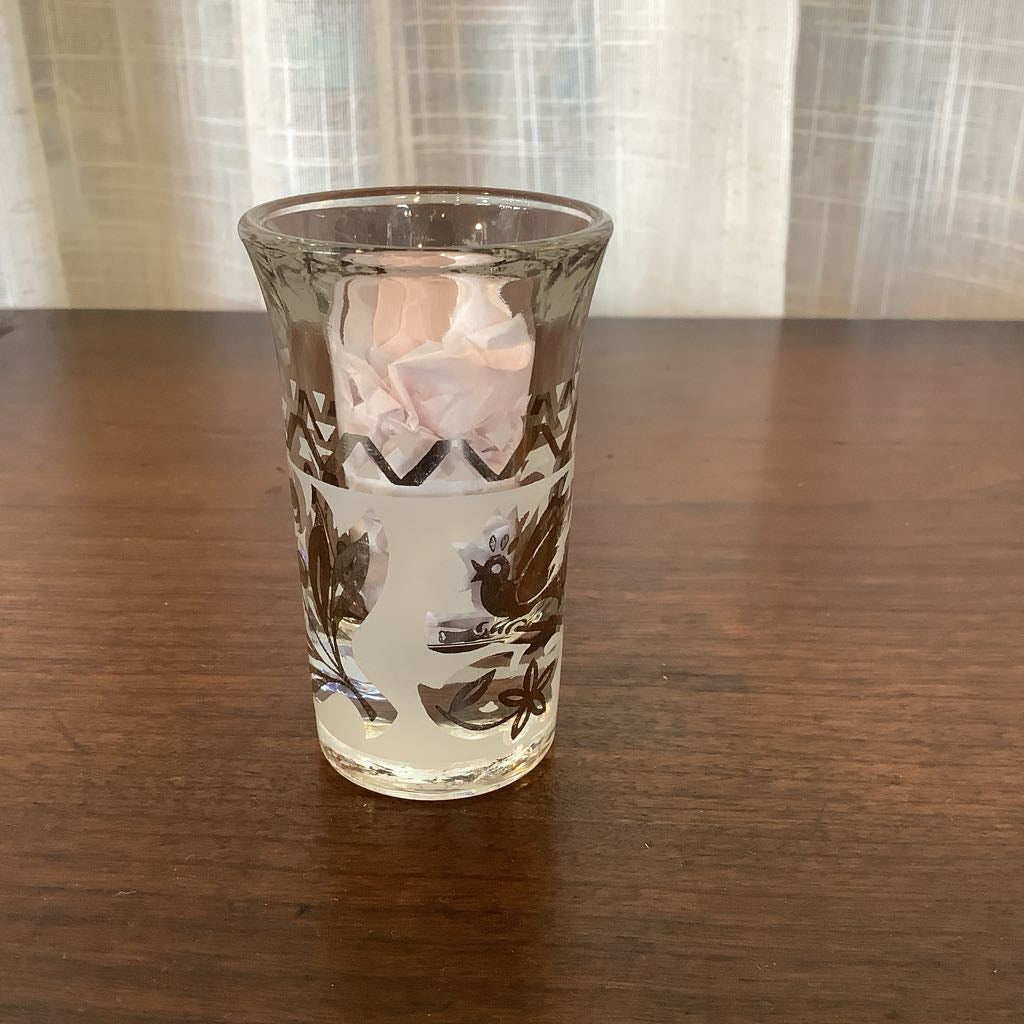 Clear glass with floral design on a wooden surface