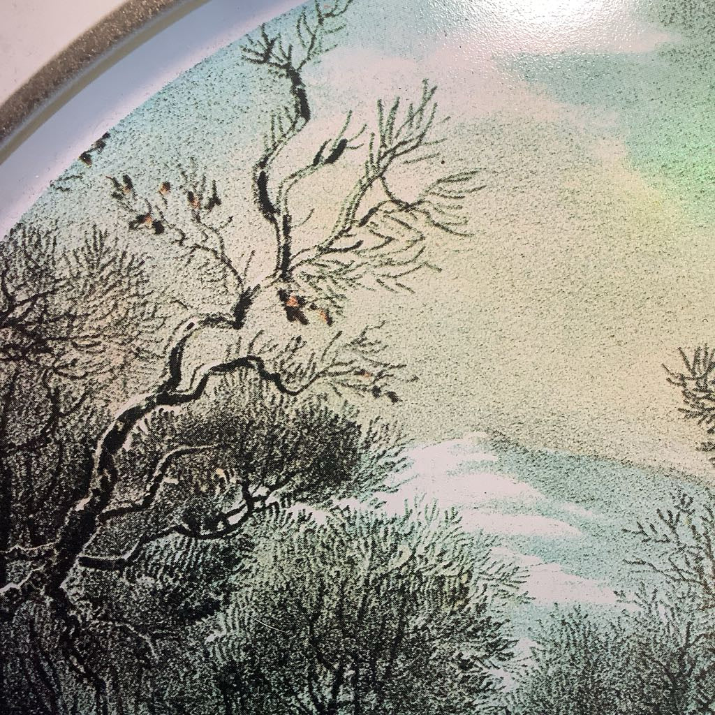 Artistic depiction of a tree with birds against a mountainous landscape