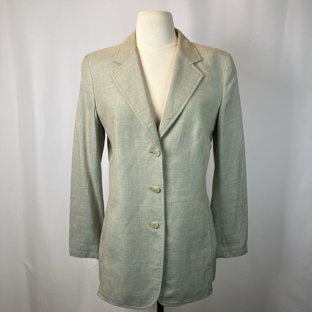 Light green blazer on a mannequin against a plain background