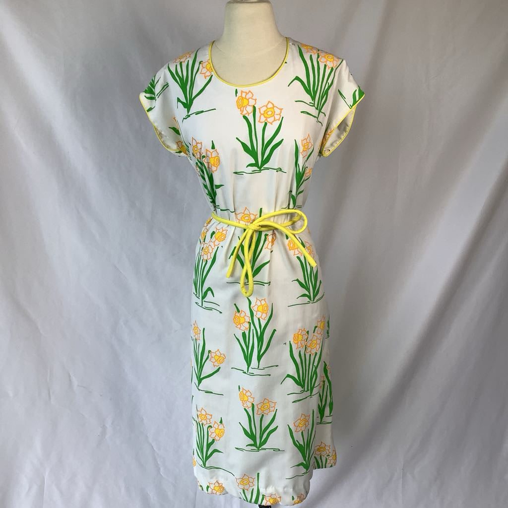 Dress with floral pattern on a mannequin against a plain background