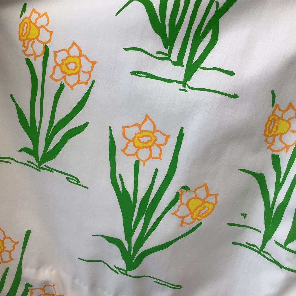 Pattern of yellow flowers with green leaves on a white background