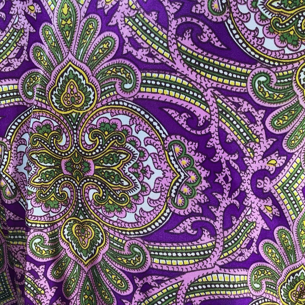Purple fabric with green and yellow paisley pattern