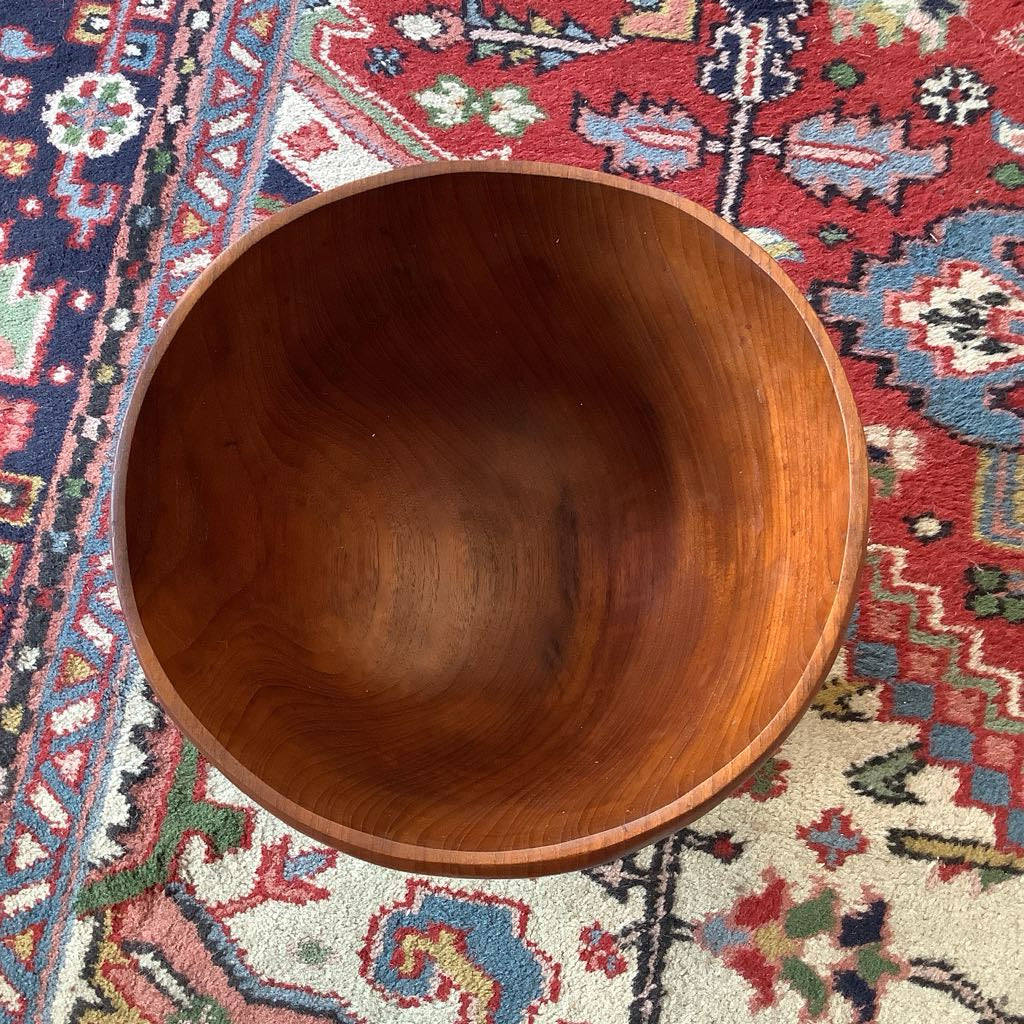 Wooden bowl on a colorful patterned rug