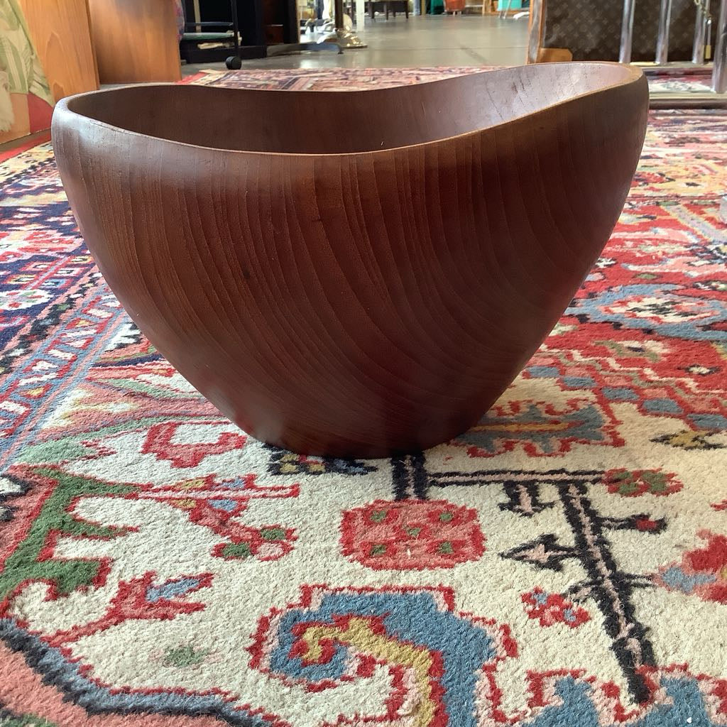 Wooden bowl on a colorful patterned rug