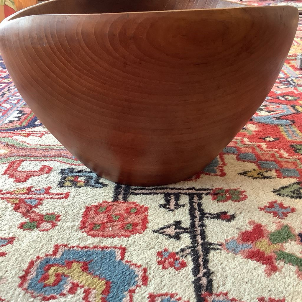 Wooden bowl on a colorful patterned rug