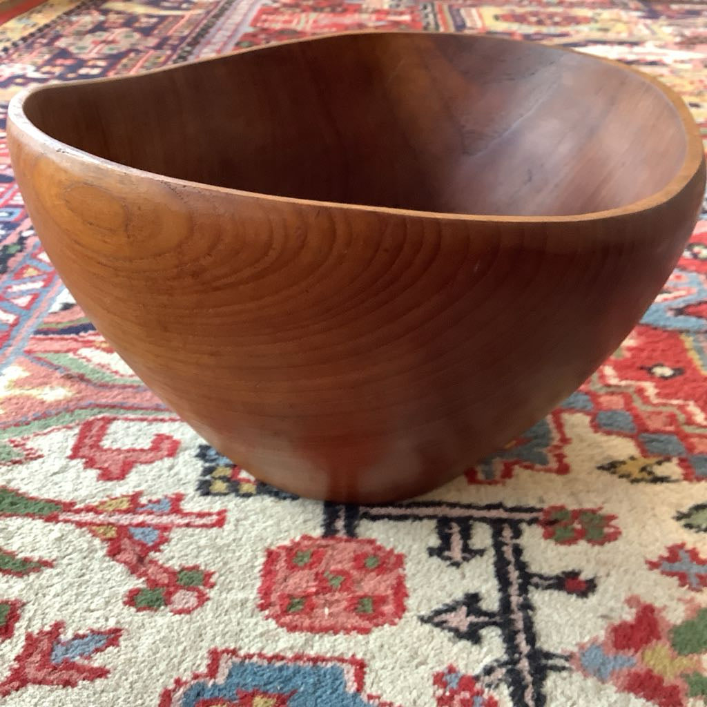 Wooden bowl on a colorful patterned rug