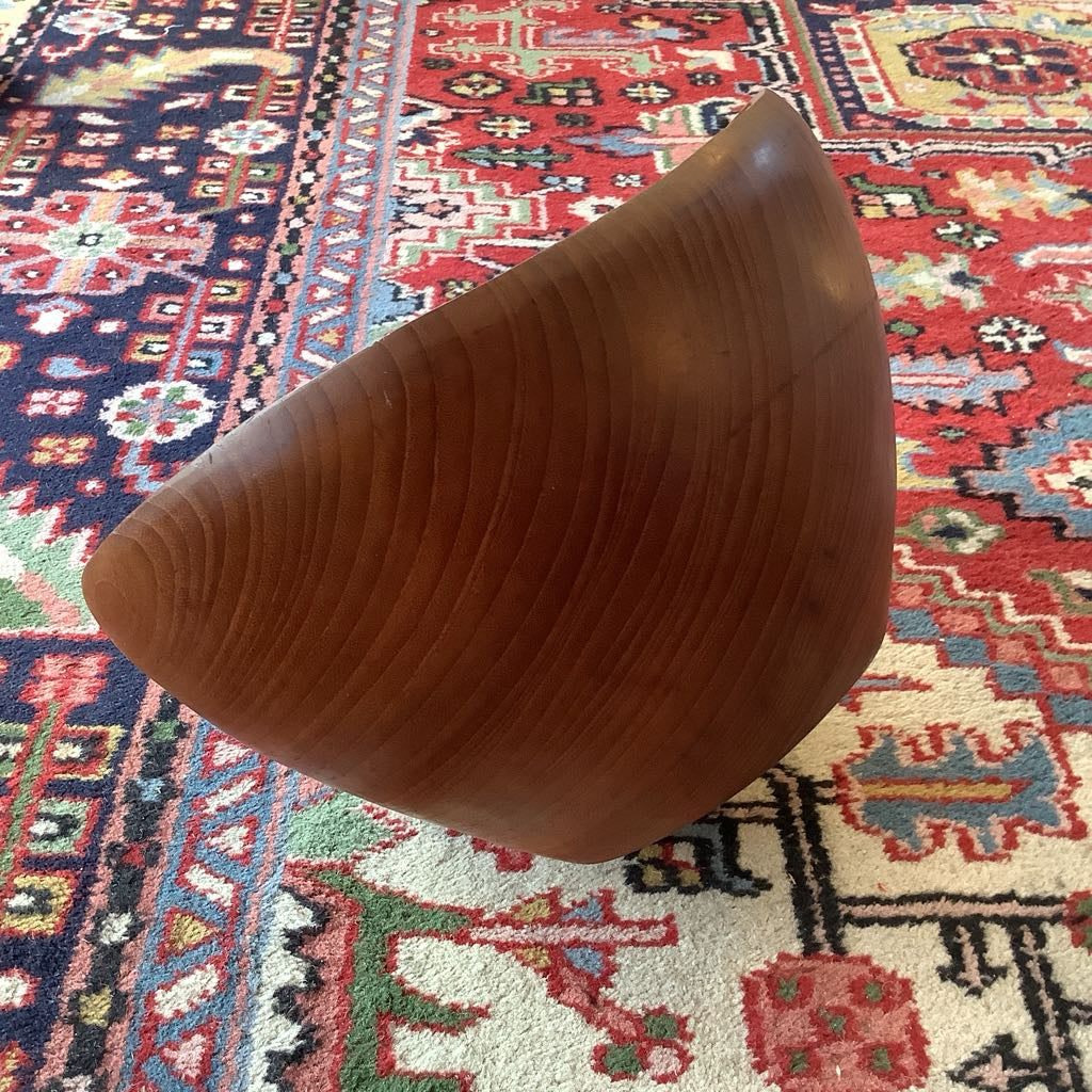 Wooden object on a colorful patterned rug