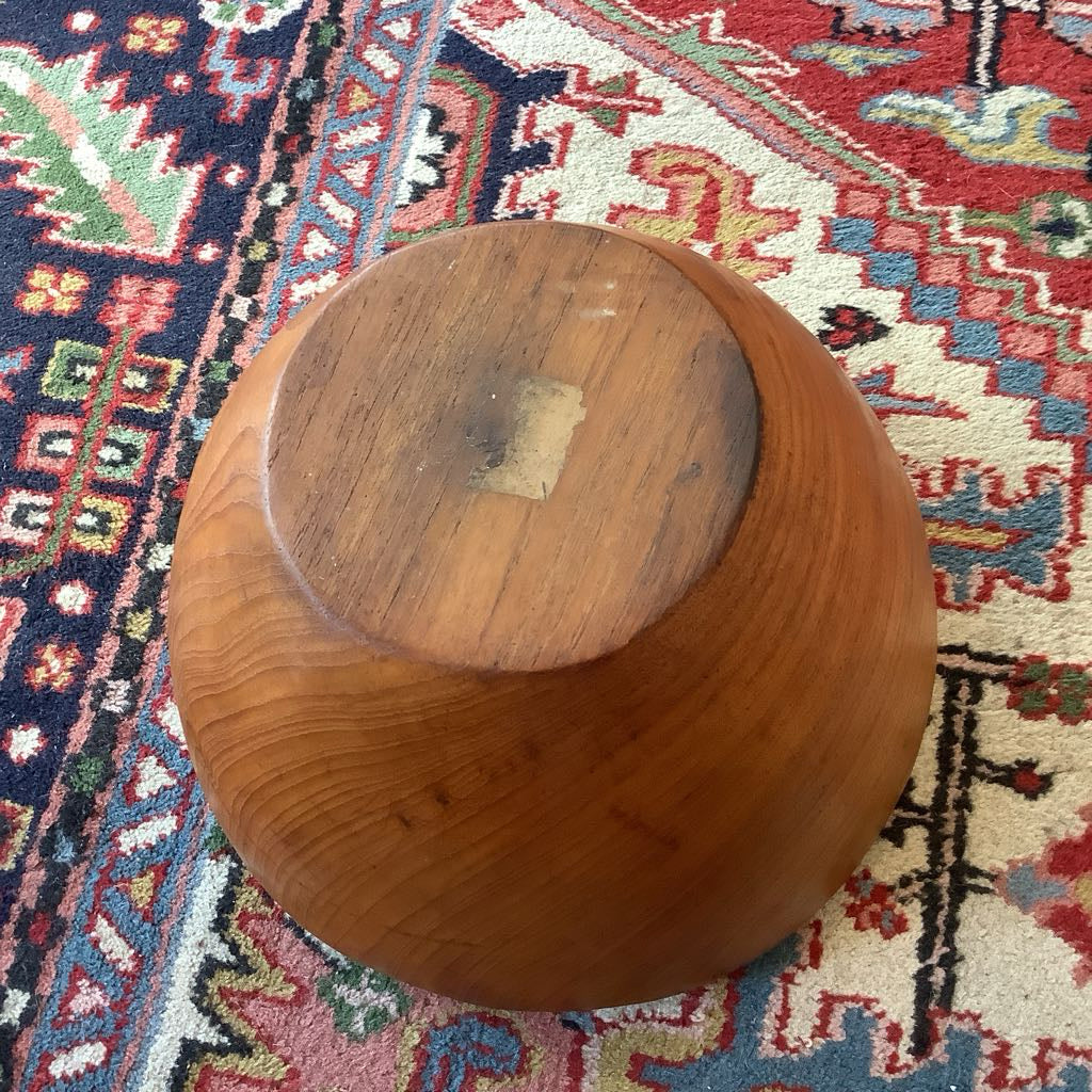 Wooden bowl on a colorful patterned rug