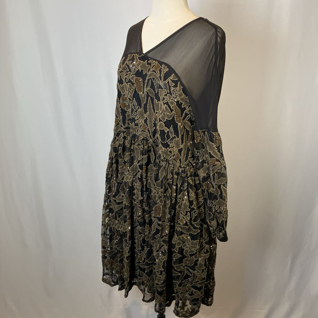 Black lace dress on a mannequin against a plain background