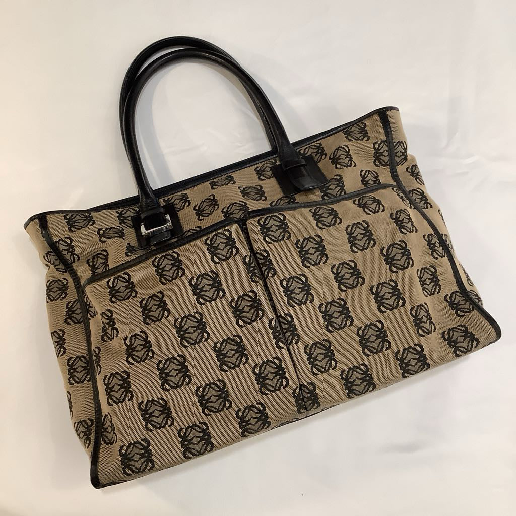 Beige handbag with black pattern on a white background
