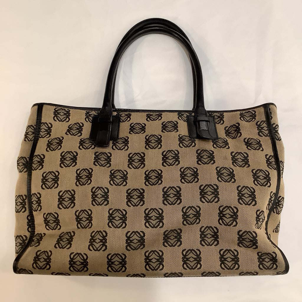 Beige handbag with black pattern on a beige background