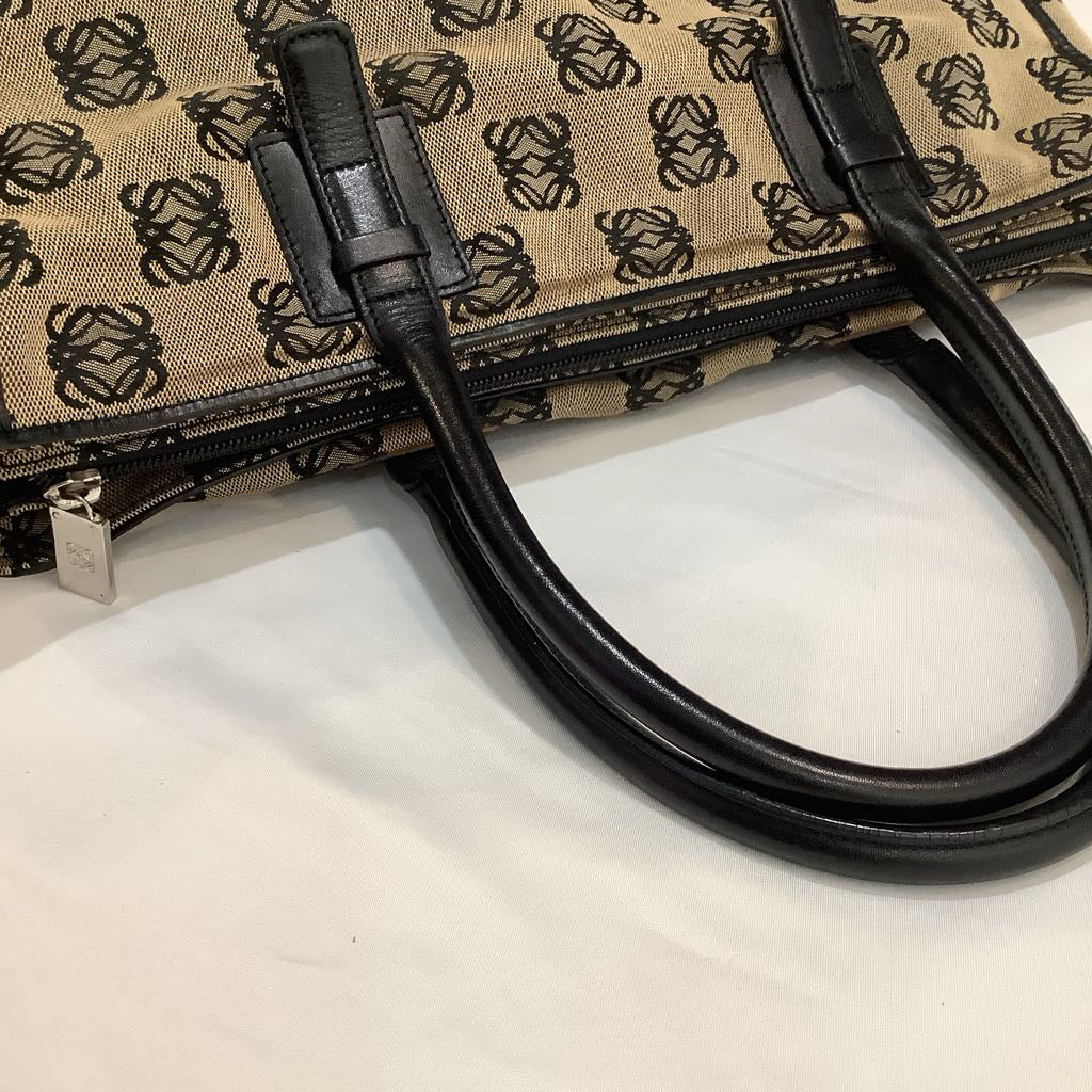 Patterned bag with black handle on a white surface