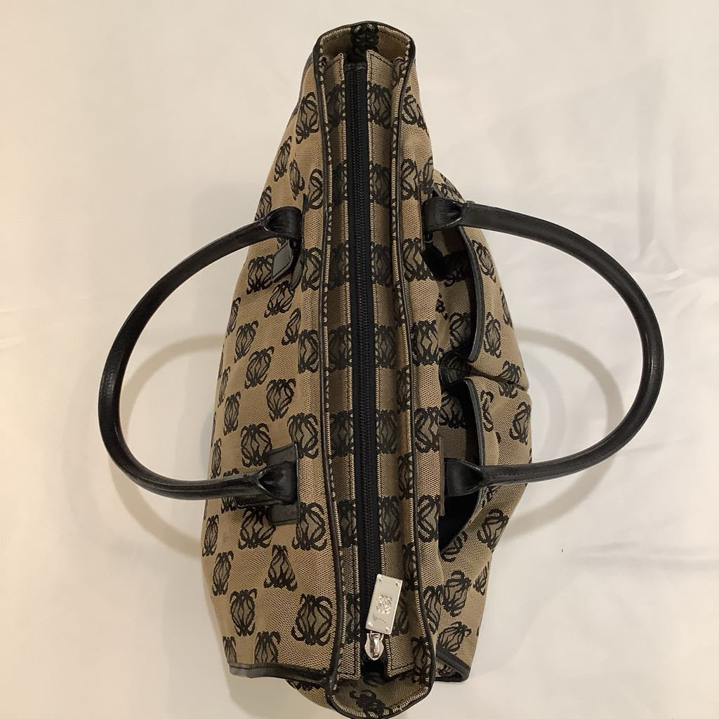 Patterned bag with black handles on a white background