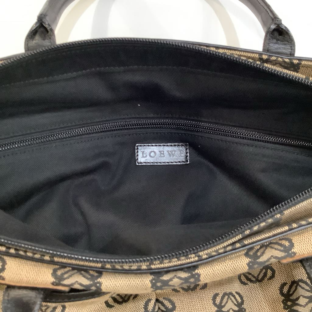 Open bag with visible brand logo on a black interior background