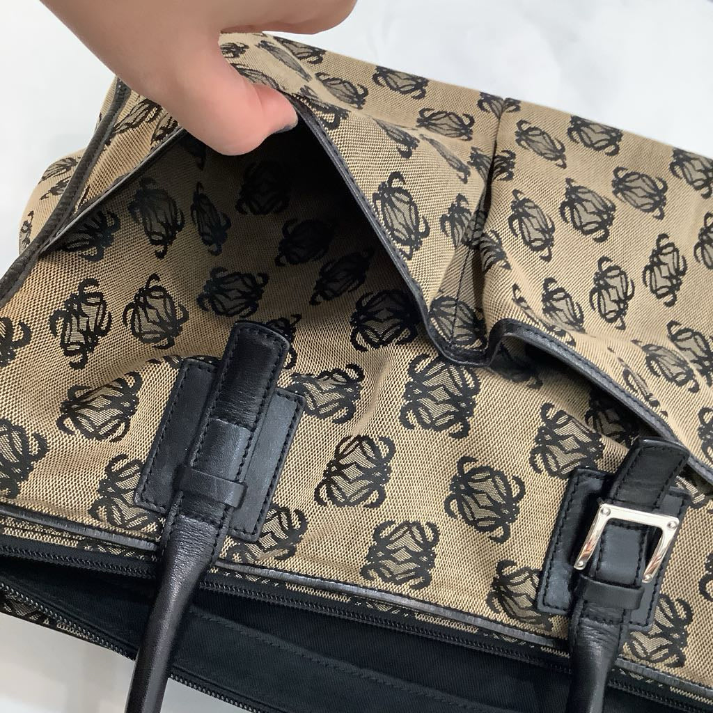 Patterned bag with black handles on a white background