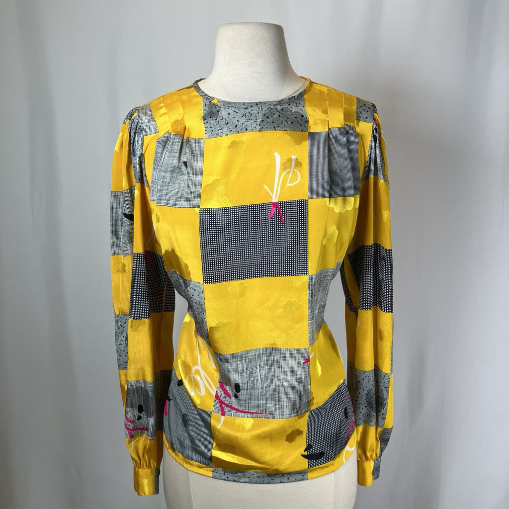 Yellow and gray checkered jacket on a mannequin against a plain background