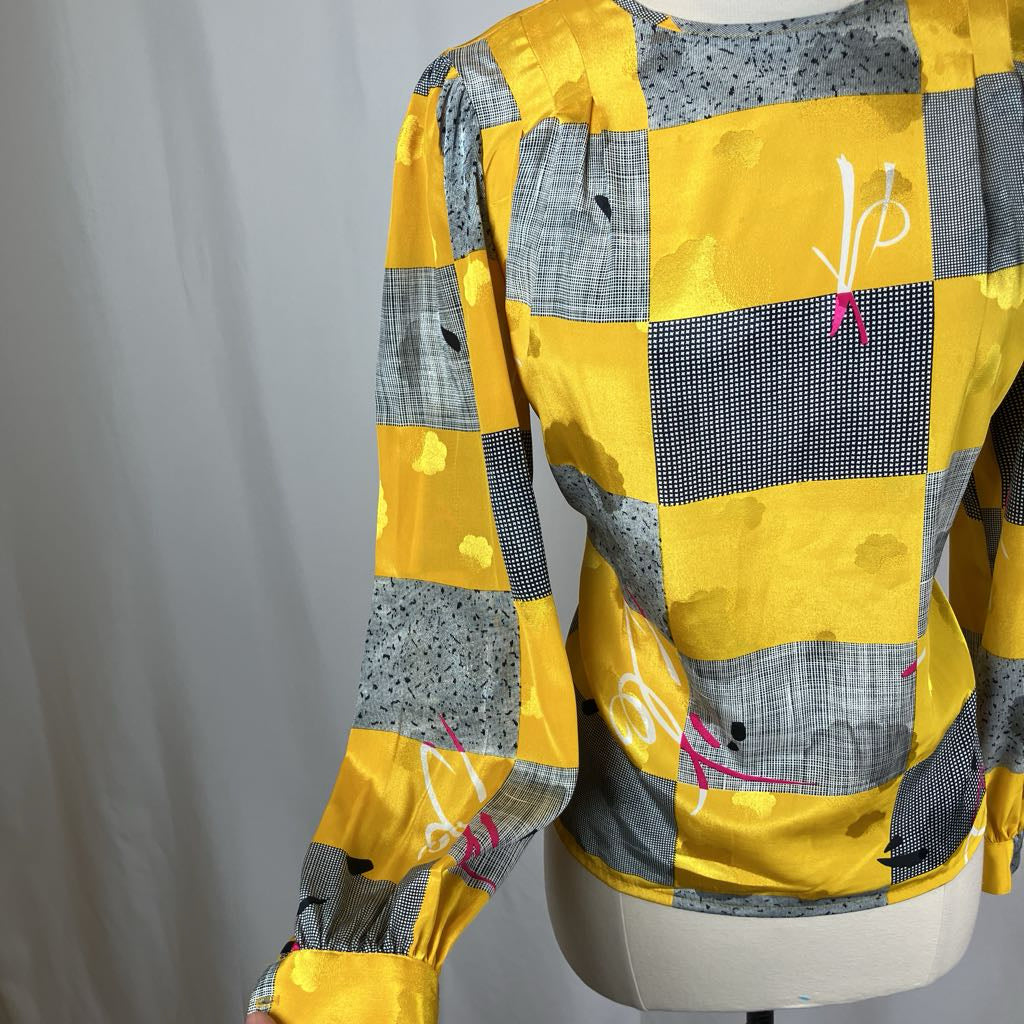 Yellow and gray checkered shirt on a mannequin against a plain background