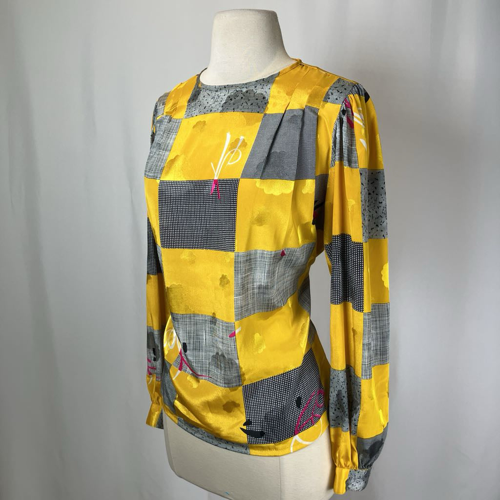 Yellow and gray checkered shirt on a mannequin against a plain background
