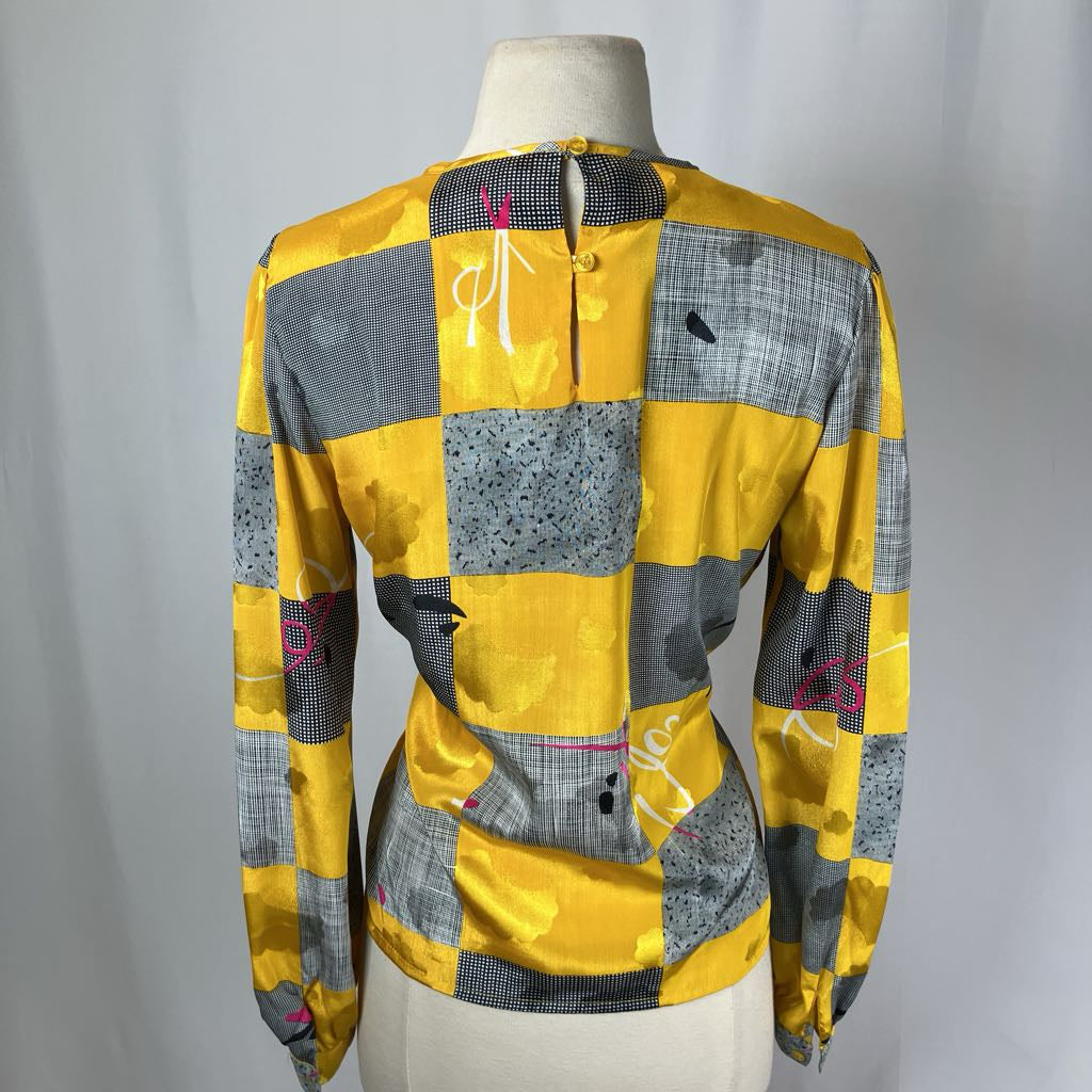 Yellow and gray checkered jacket on a mannequin against a plain background