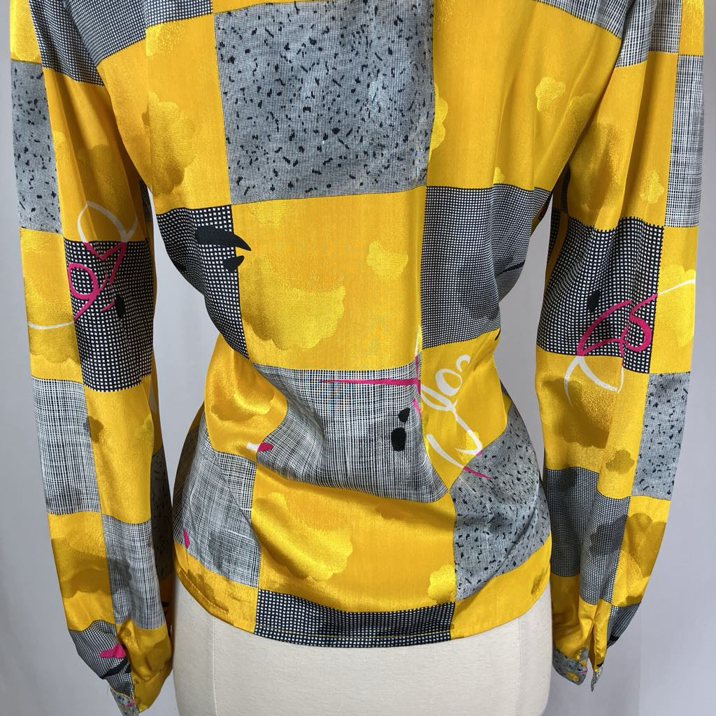 Yellow and gray patchwork jacket on a mannequin against a gray background