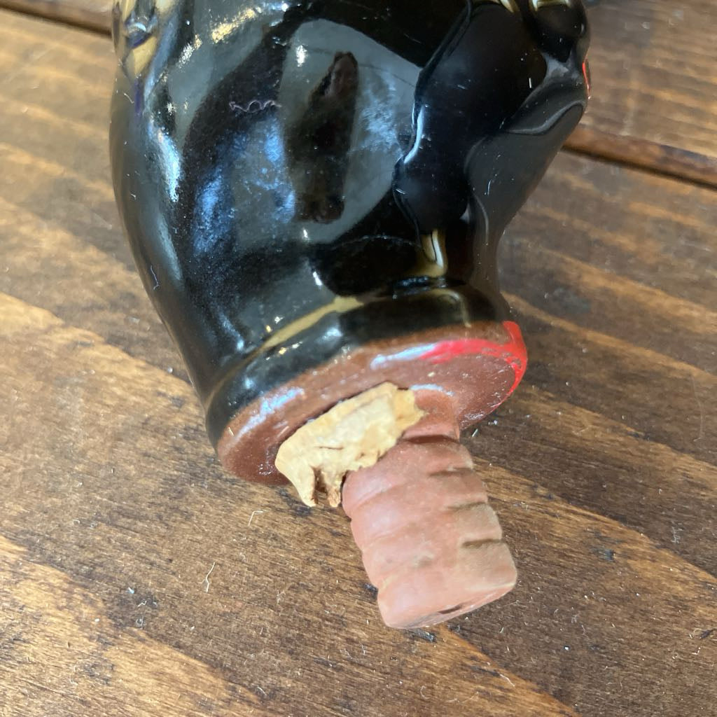 Wine bottle with cork on a wooden surface