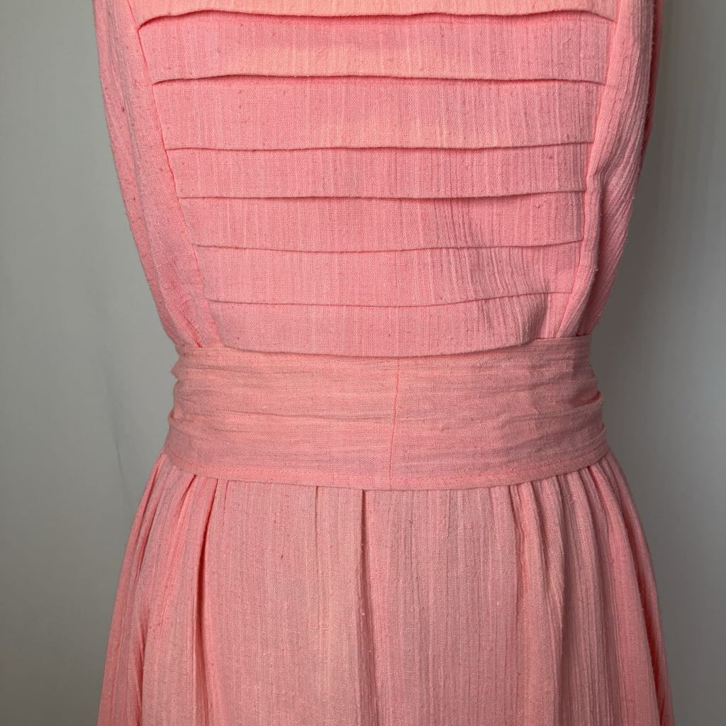 Pink dress with pleated bodice on a gray background
