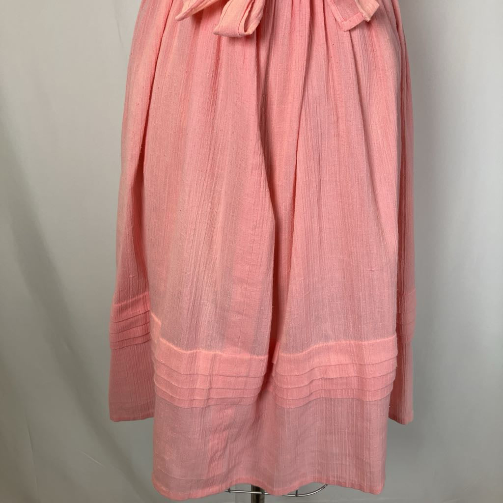 Pink dress with a belt on a gray background