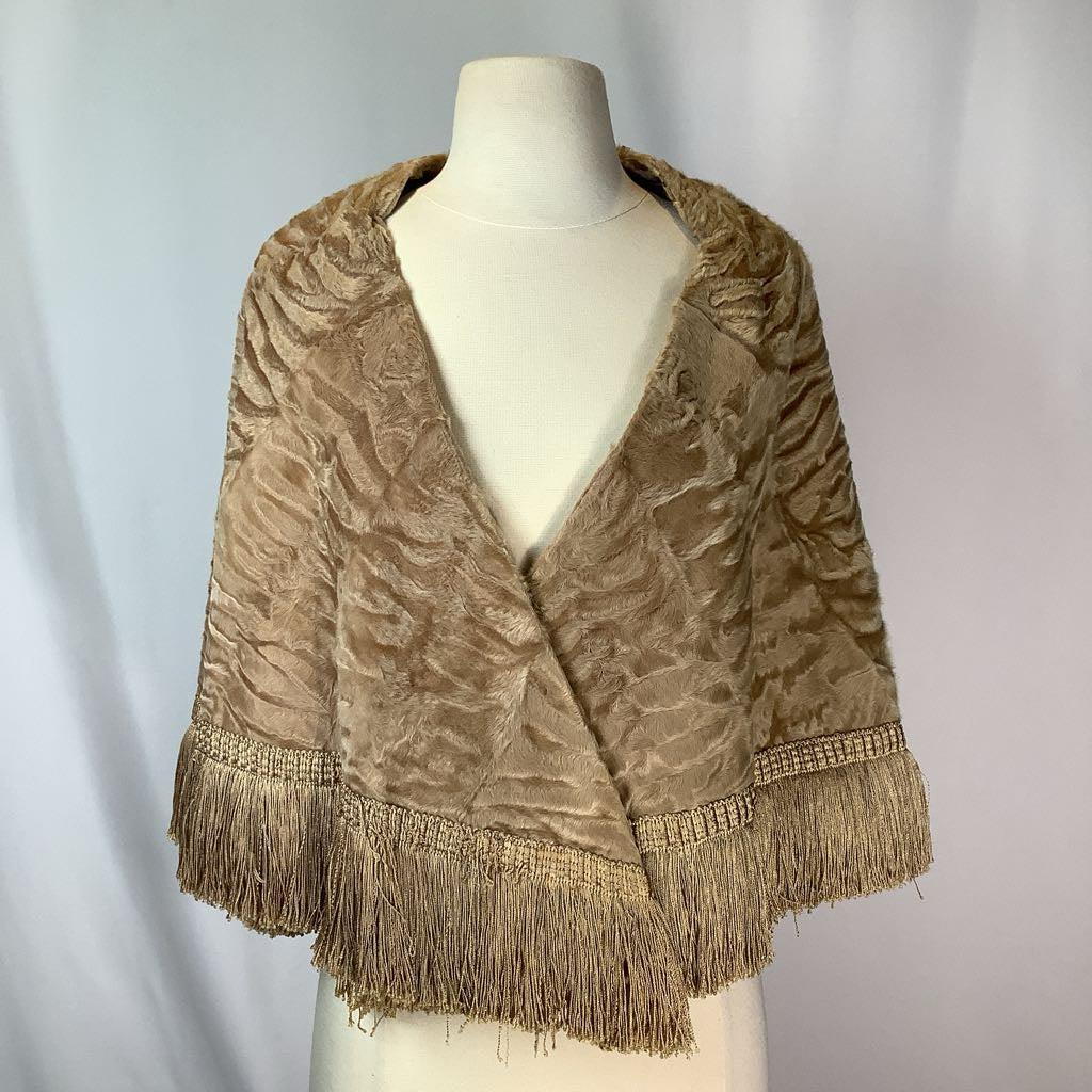 Beige textured shawl with fringe on a mannequin against a plain background