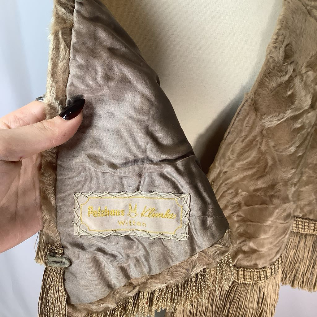 Close-up of a textured fabric with a brand label on a neutral background