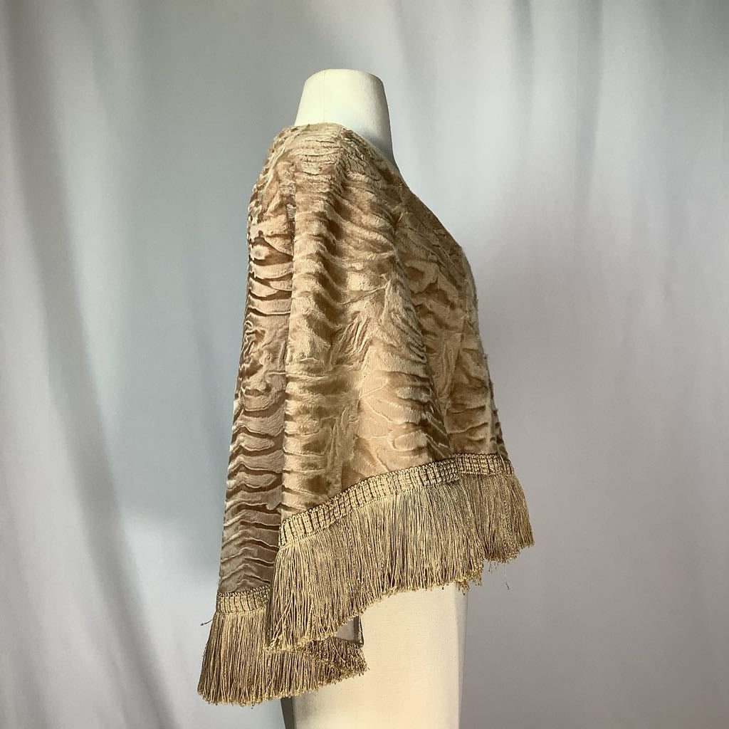 Mannequin wearing a gold textured jacket with fringe details against a plain background