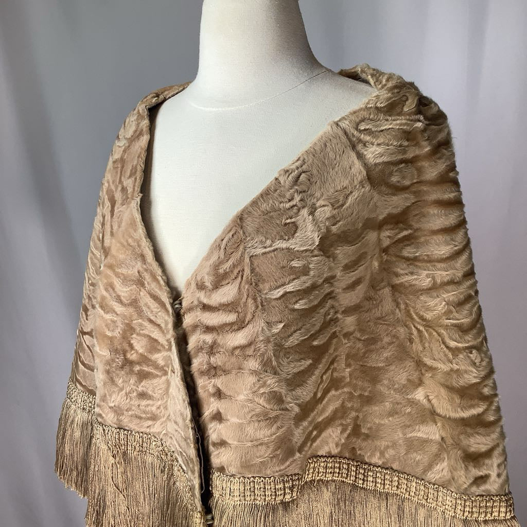 Beige textured shawl on a mannequin against a plain background
