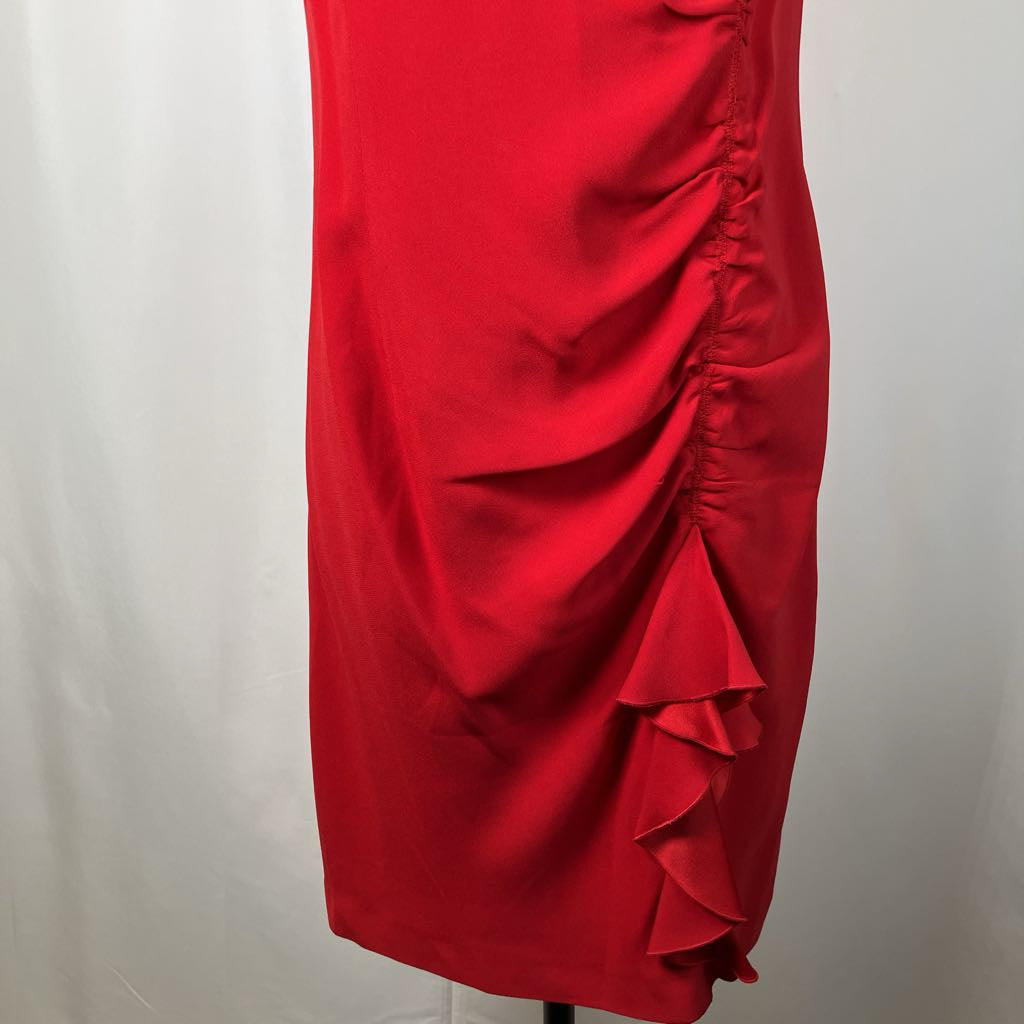 Red dress with ruffled details on a white background