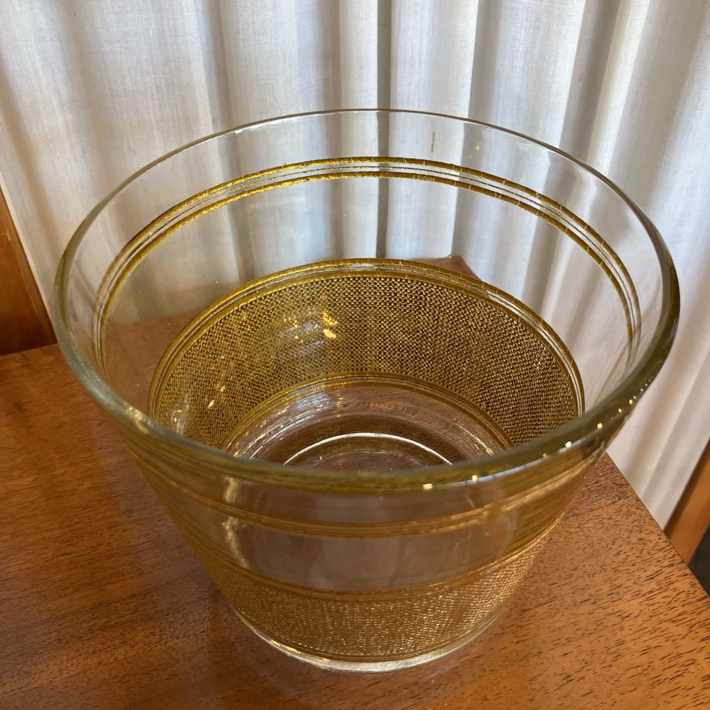 Over head view of gold embossed ice bucket on a wooden surface