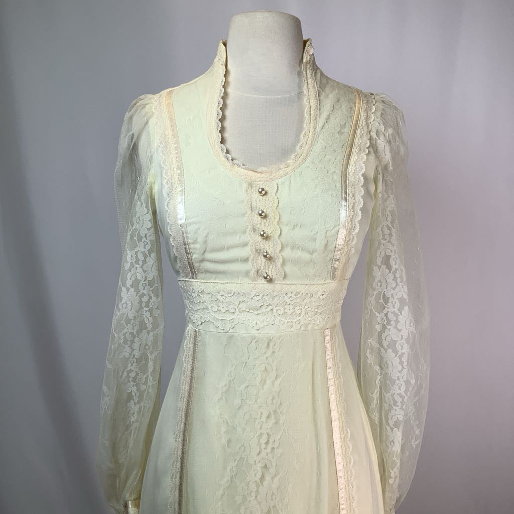 Light green lace dress on a mannequin against a gray background