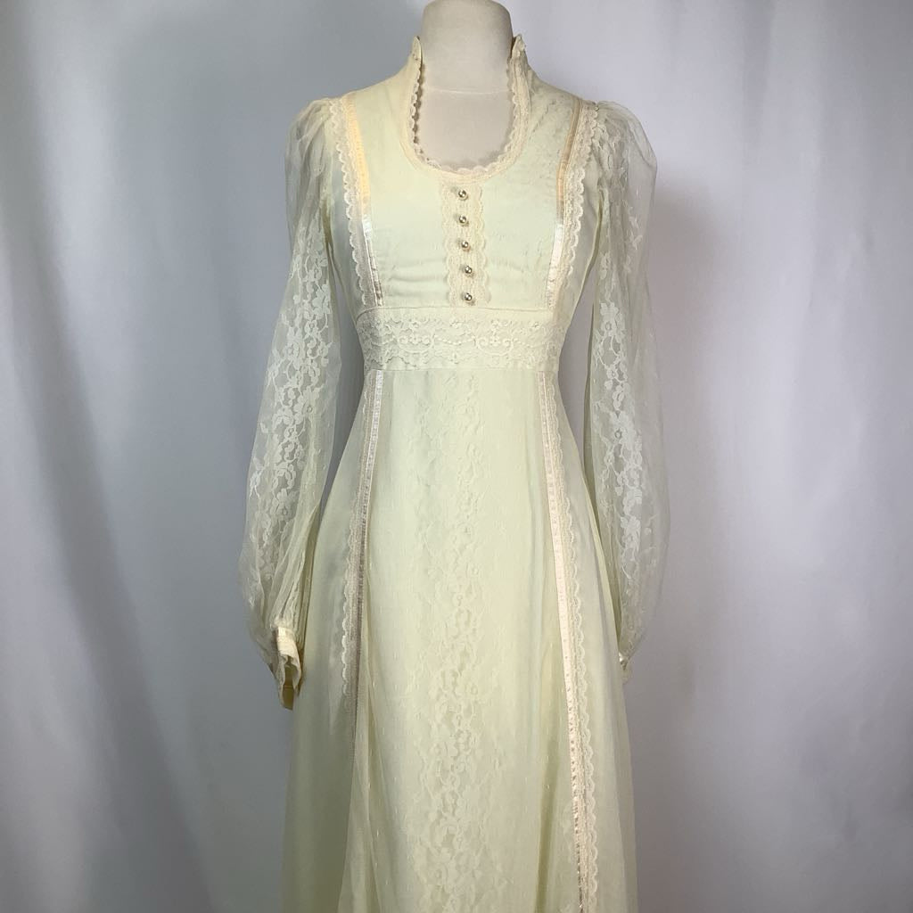 Light green lace dress on a mannequin against a plain background