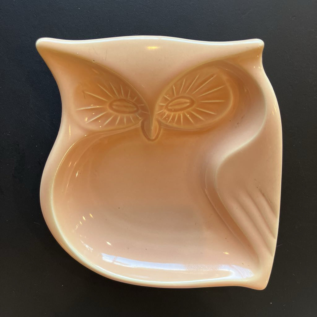 Ceramic owl-shaped bowl on a black background