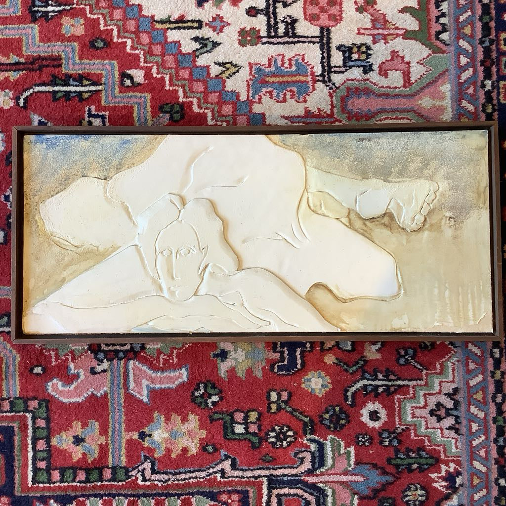 Decorative wall art on a red and multicolored patterned rug