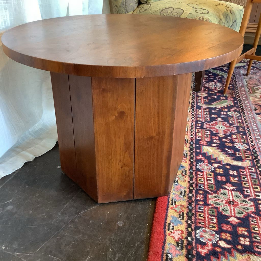 Wooden table in a room with a patterned rug and chair
