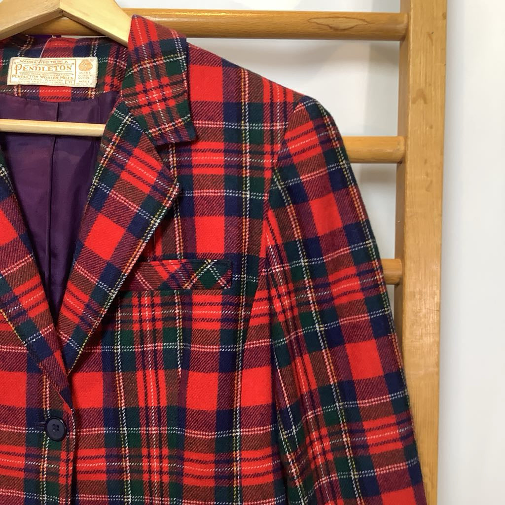 Red and green plaid jacket on a wooden rack