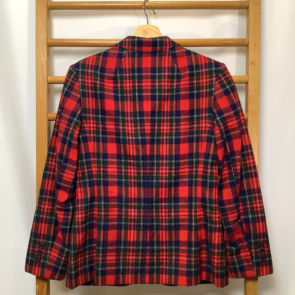 Red and blue plaid shirt on a wooden rack