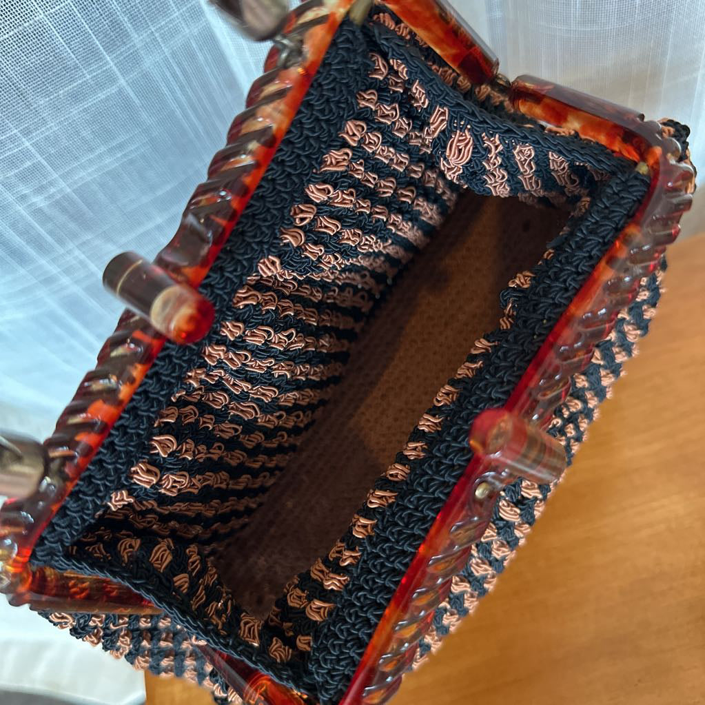 Decorative box with intricate design on a wooden surface