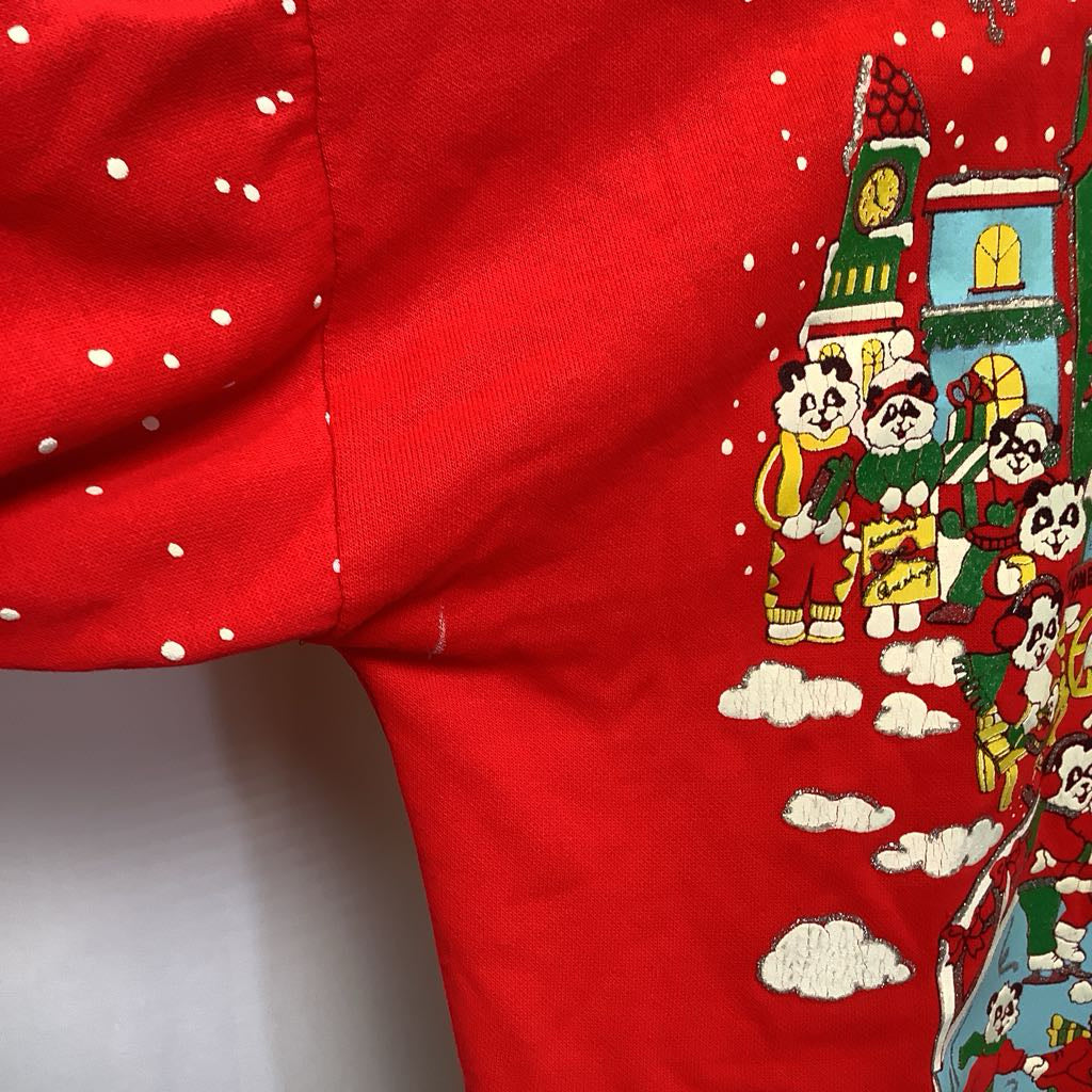 Red fabric with cartoon panda design and festive elements on a white background
