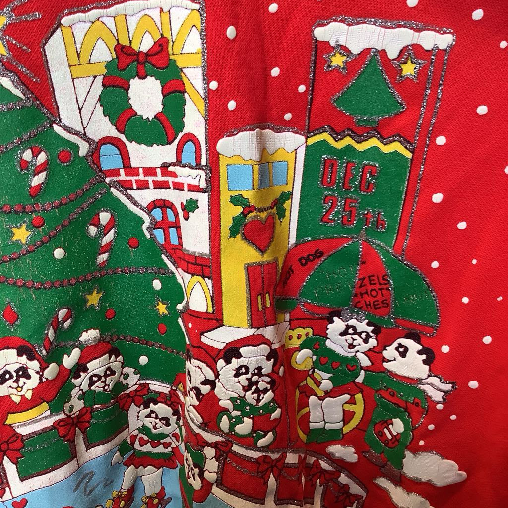 Christmas-themed fabric with festive designs and text on a red background.