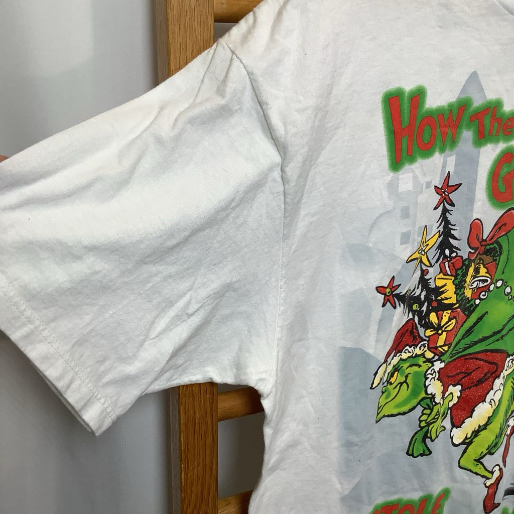 White t-shirt with a colorful graphic design on a wooden hanger against a white background