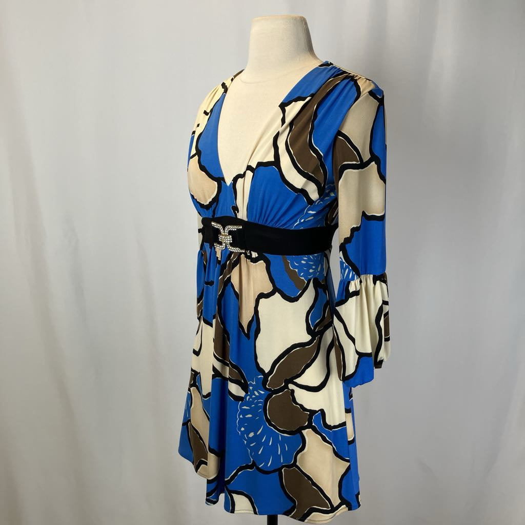 Colorful dress on a mannequin against a plain background